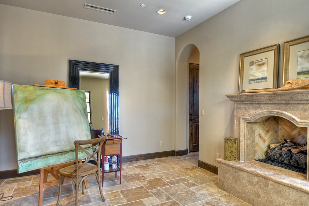 Example of a large classic home office design in Phoenix with beige walls and a stone fireplace