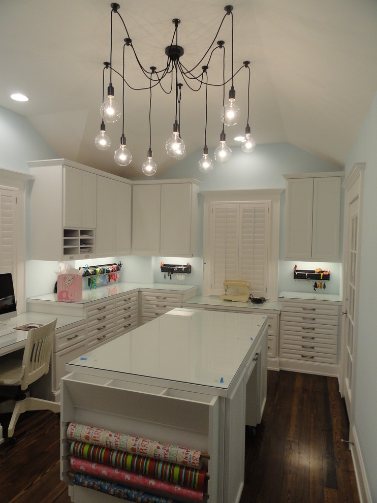 Example of a classic built-in desk craft room design in Houston with blue walls