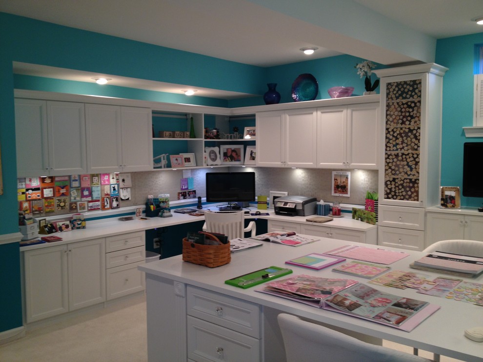 Craft room - large traditional built-in desk carpeted and brown floor craft room idea in Philadelphia with blue walls