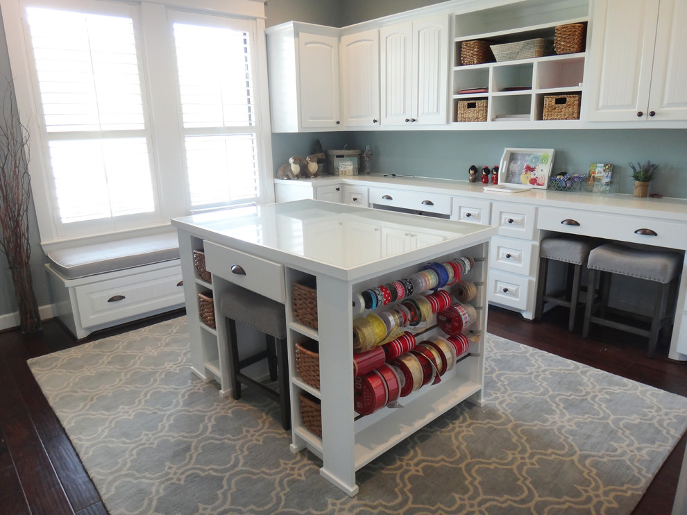 Large classic craft room in Houston with blue walls, dark hardwood flooring and a built-in desk.