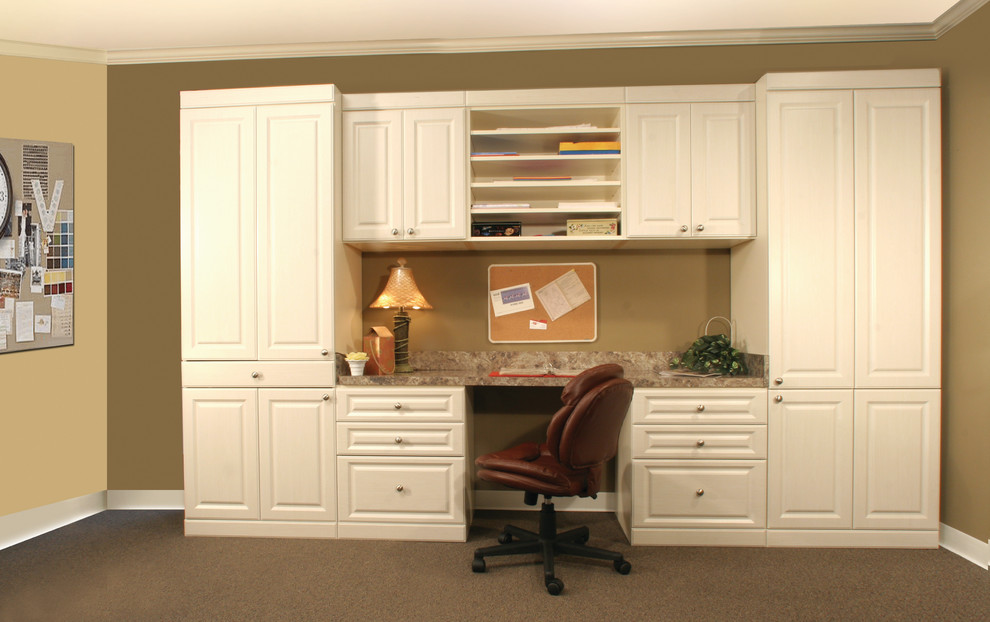 Craft room - mid-sized traditional built-in desk carpeted craft room idea in Orange County with beige walls and no fireplace