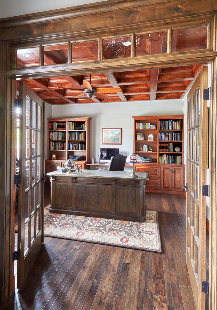 Large traditional home office in Chicago with grey walls, dark hardwood flooring, no fireplace and a freestanding desk.