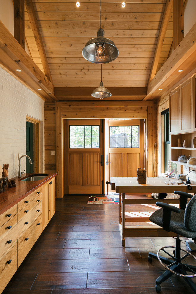 Example of a small farmhouse freestanding desk dark wood floor and brown floor home studio design in Atlanta with brown walls and no fireplace