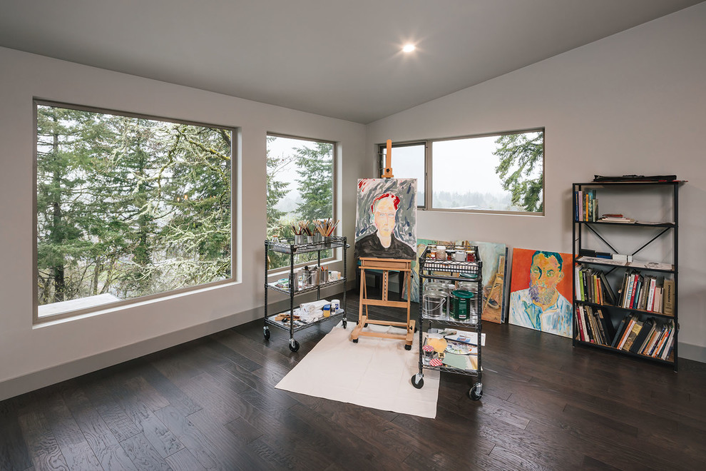 Großes Rustikales Arbeitszimmer mit Studio, weißer Wandfarbe, dunklem Holzboden, Kamin, freistehendem Schreibtisch und braunem Boden in Portland