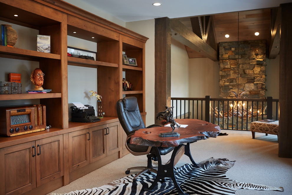 Photo of a rustic study in Grand Rapids with beige walls, carpet, no fireplace and a freestanding desk.