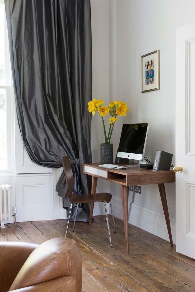 Photo of a medium sized contemporary home office in London with white walls, medium hardwood flooring and a freestanding desk.