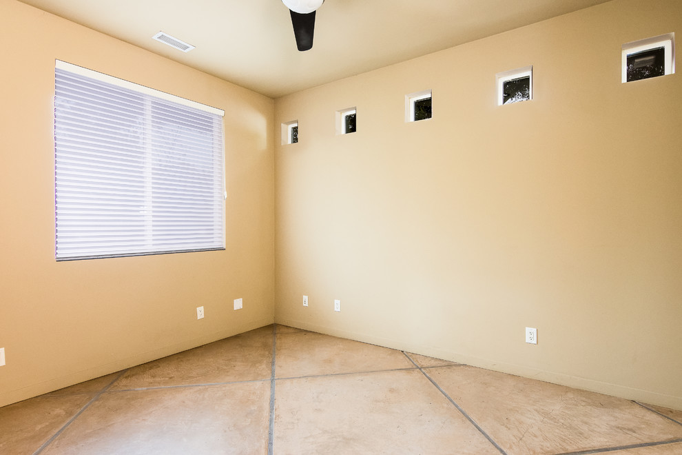 Large trendy concrete floor and beige floor study room photo in Portland with beige walls
