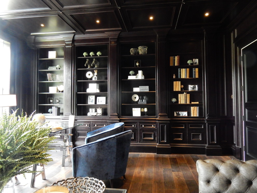 Inspiration for a large classic study in Surrey with black walls, dark hardwood flooring, a standard fireplace, a stone fireplace surround, a freestanding desk and brown floors.