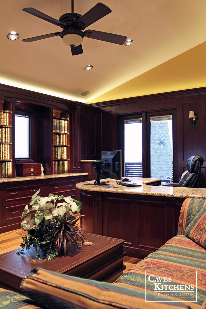 Large elegant built-in desk medium tone wood floor study room photo in New York with yellow walls