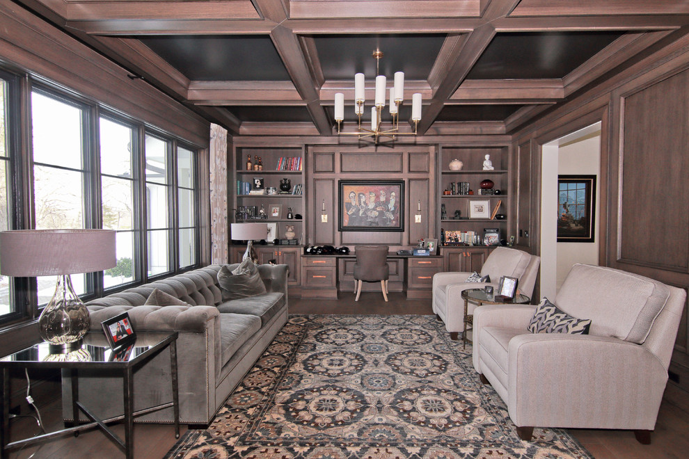 Photo of an expansive classic study in Chicago with dark hardwood flooring, a built-in desk and brown floors.