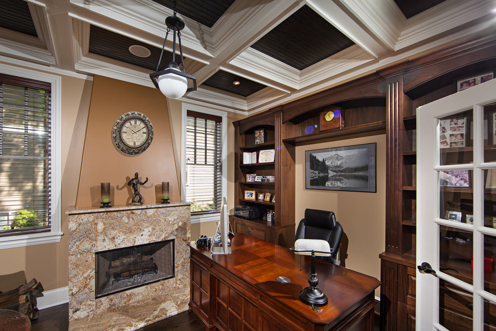 Study room - mid-sized traditional freestanding desk dark wood floor study room idea in Chicago with a standard fireplace and a stone fireplace