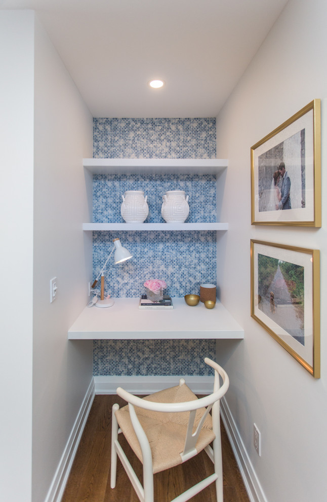 Beach style built-in desk medium tone wood floor and brown floor study room photo in Toronto with white walls