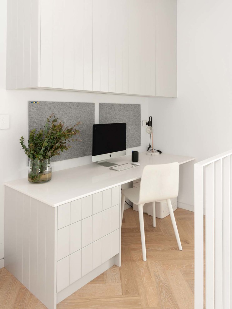 Ispirazione per un ufficio moderno di medie dimensioni con pareti bianche, scrivania incassata, parquet chiaro e pavimento beige