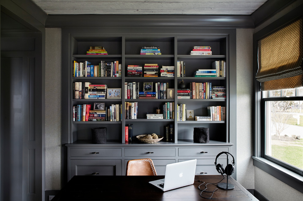 Elegant freestanding desk carpeted study room photo in New York with gray walls and no fireplace