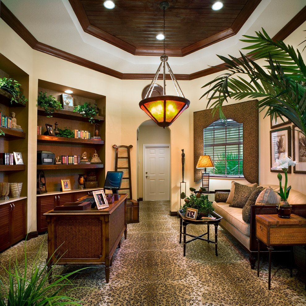 Example of an island style freestanding desk carpeted home office design in Miami with beige walls