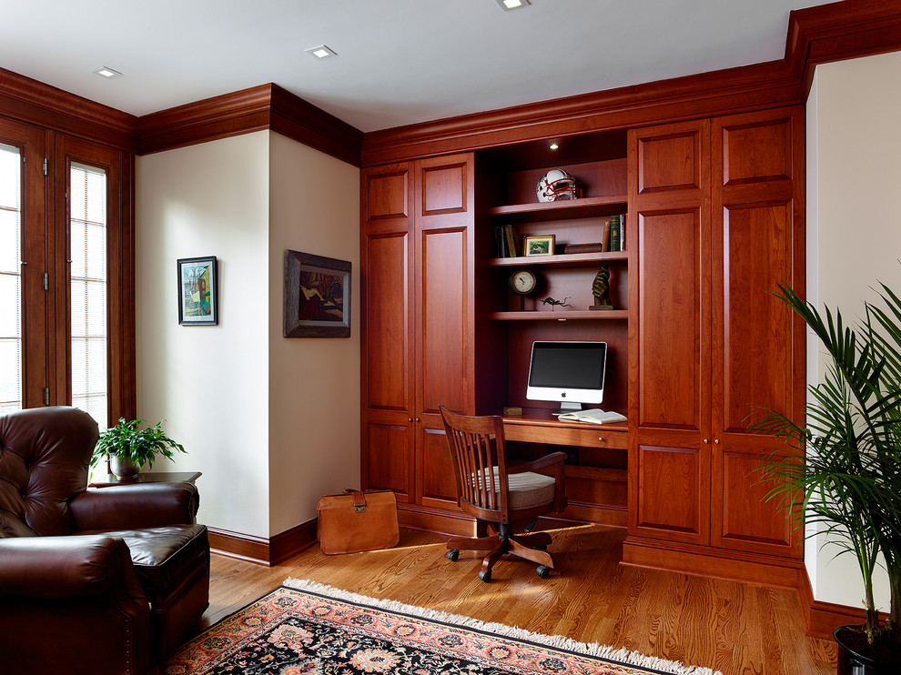 Inspiration for a classic study in Philadelphia with medium hardwood flooring, a built-in desk and white walls.