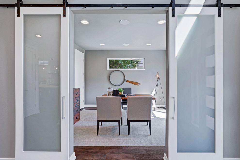 Home office - contemporary freestanding desk dark wood floor home office idea in Seattle