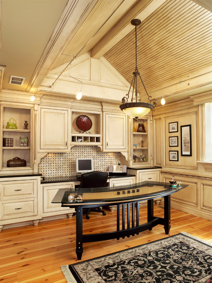 Exempel på ett klassiskt arbetsrum, med beige väggar, mellanmörkt trägolv och ett fristående skrivbord