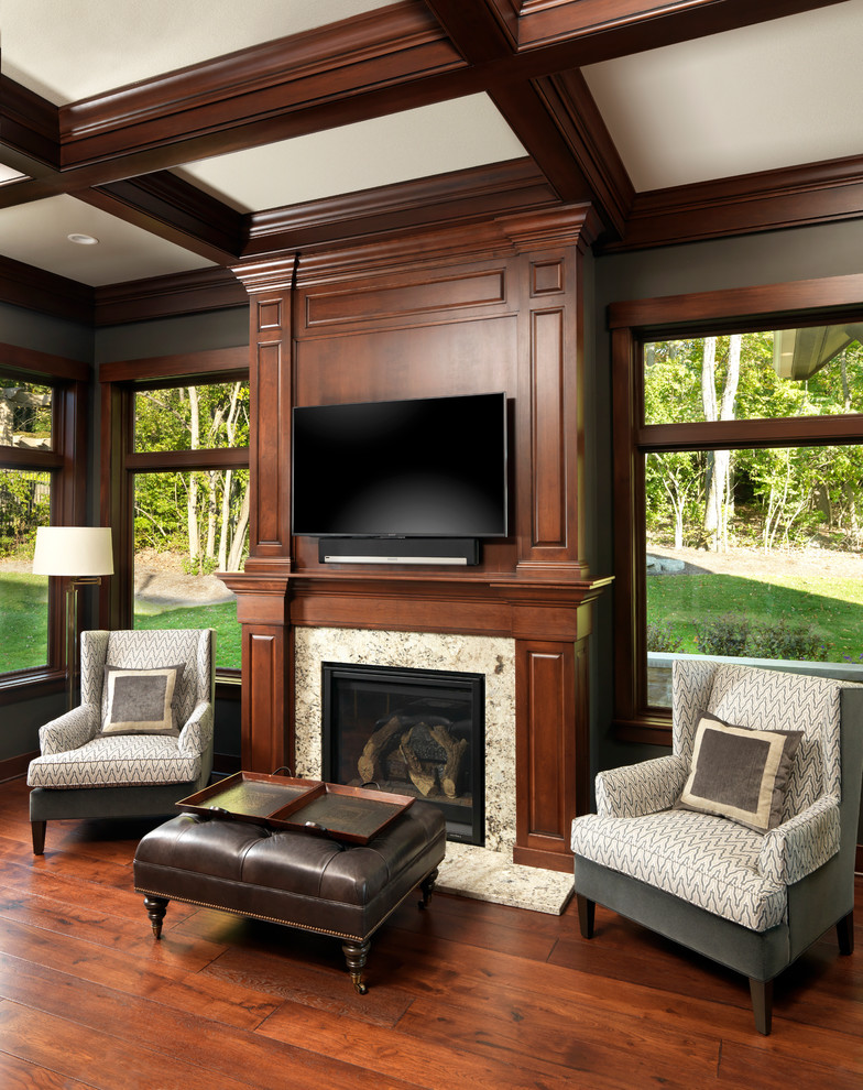 Mid-sized elegant medium tone wood floor study room photo in Other with brown walls, a standard fireplace and a stone fireplace