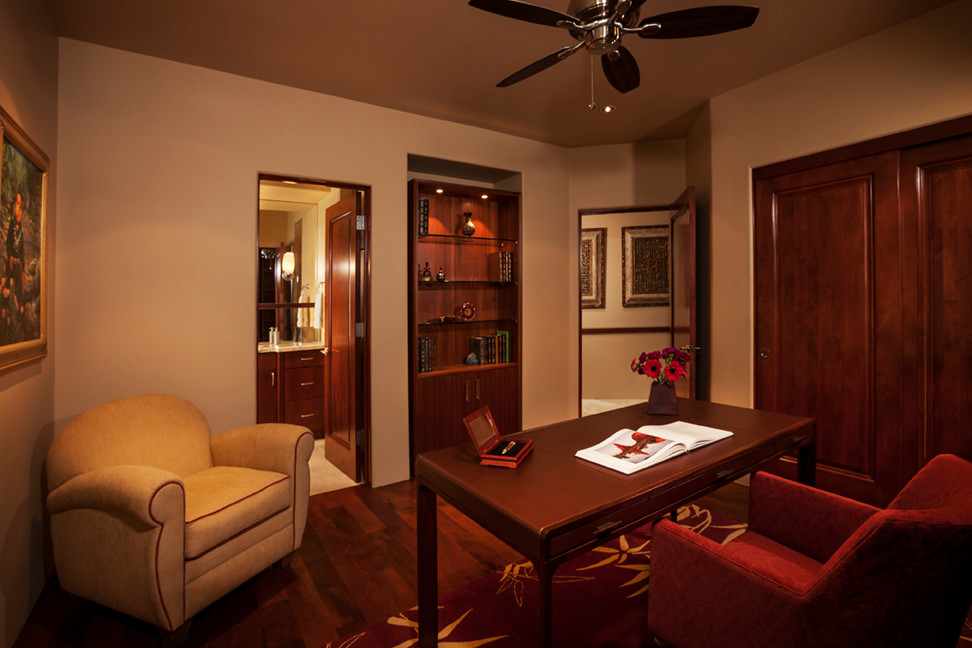Mittelgroßes Modernes Arbeitszimmer mit beiger Wandfarbe, braunem Holzboden, freistehendem Schreibtisch und braunem Boden in Phoenix