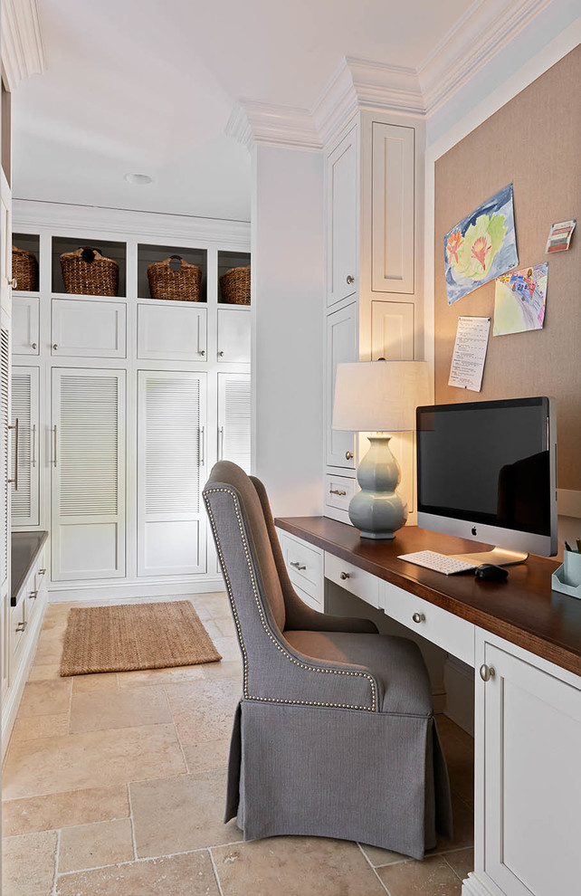 Photo of a traditional home office in Charlotte with white walls and beige floors.