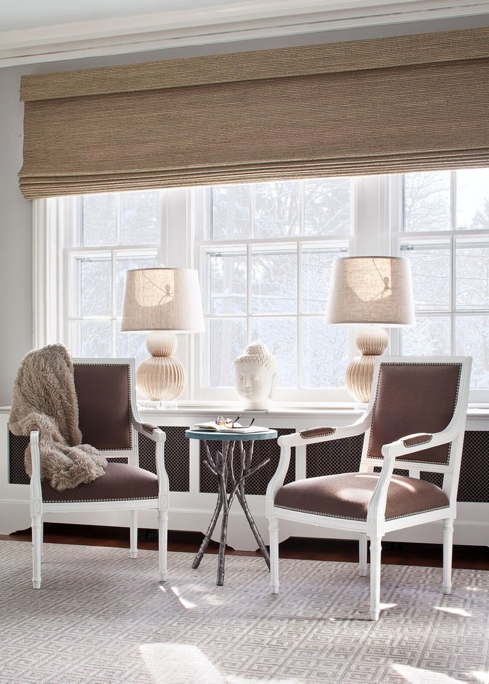 Photo of a large traditional home office in New York with grey walls and brown floors.