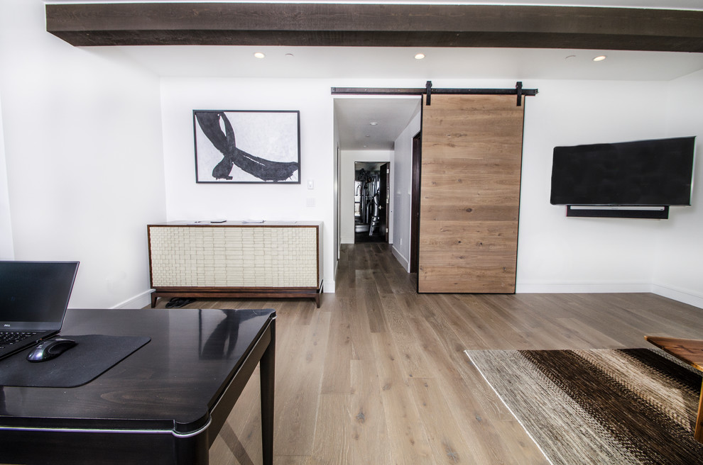 Photo of a contemporary study in Denver with white walls, light hardwood flooring and a freestanding desk.