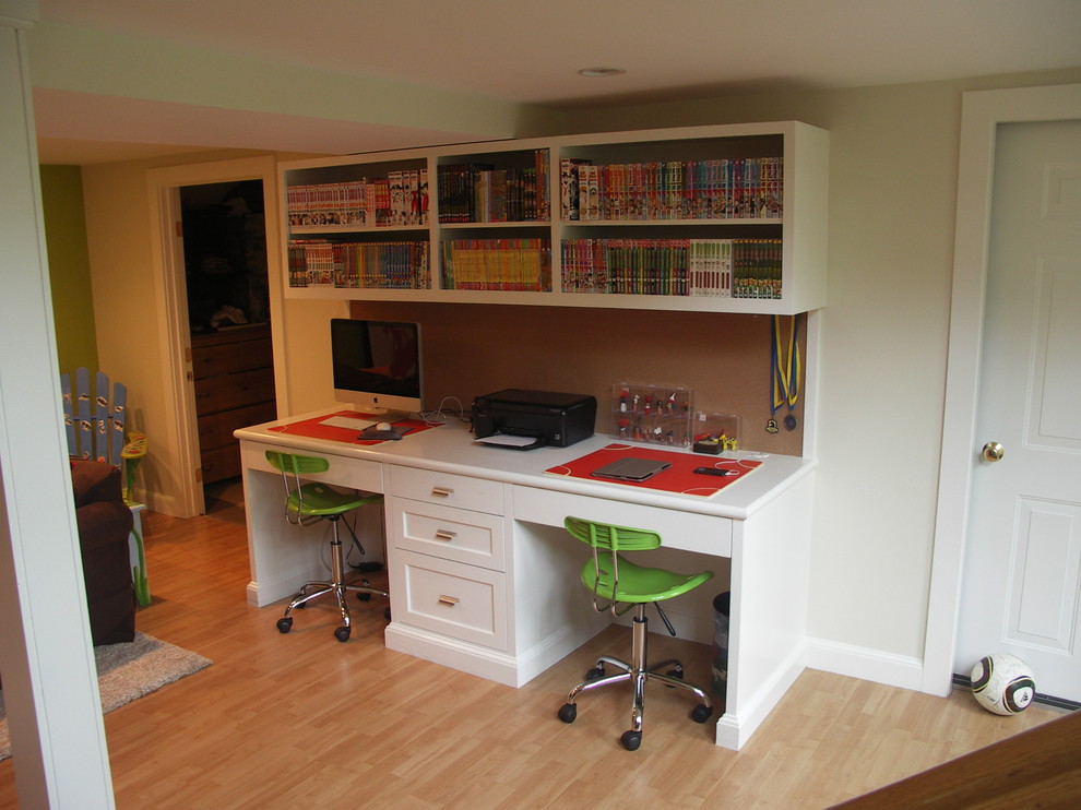 Example of a mid-sized trendy built-in desk light wood floor craft room design in Boston with beige walls and no fireplace