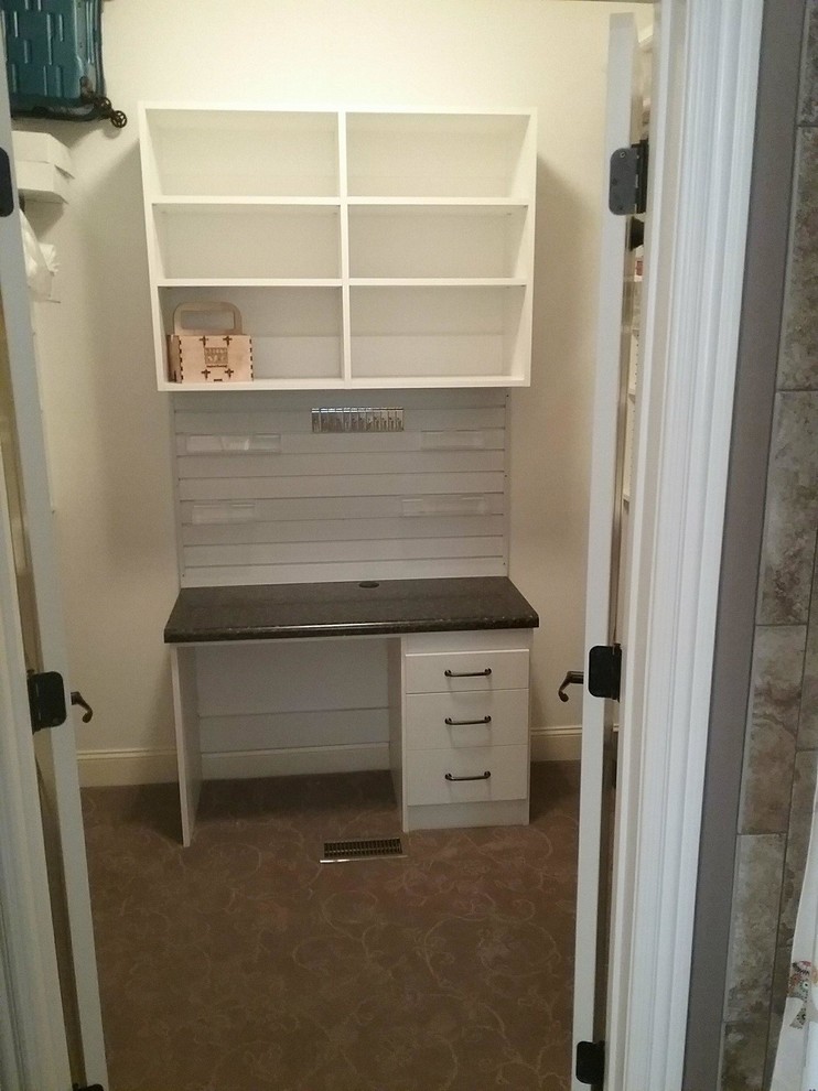 Inspiration for a mid-sized built-in desk craft room remodel in Other