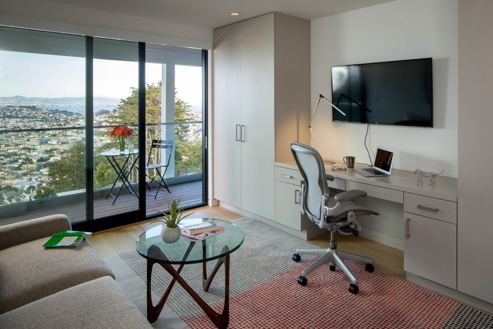 Idee per un grande ufficio minimal con pareti beige, parquet chiaro, nessun camino e scrivania incassata