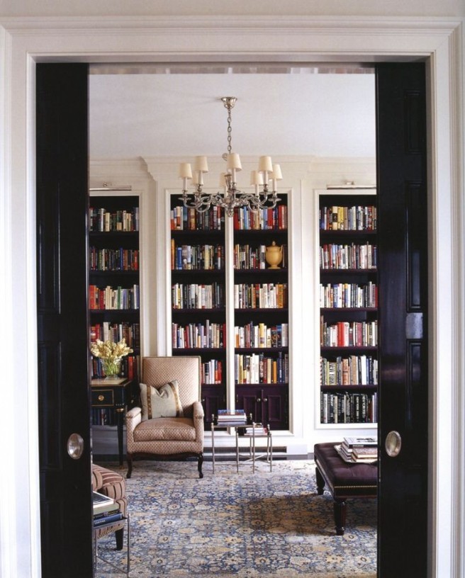 This is an example of a large modern study in New York with beige walls, carpet and no fireplace.