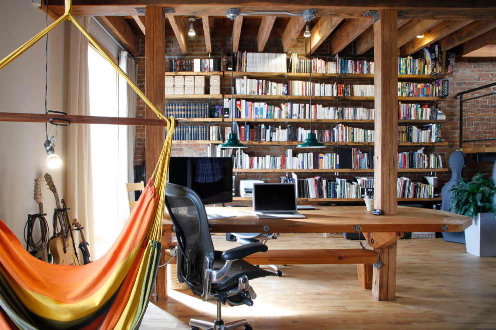 Home office - industrial freestanding desk light wood floor home office idea in Montreal