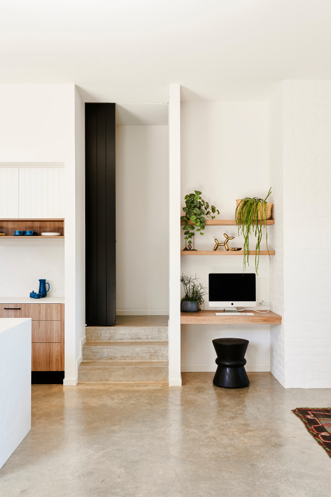 Inspiration for a small contemporary study in Geelong with white walls, a built-in desk and grey floors.