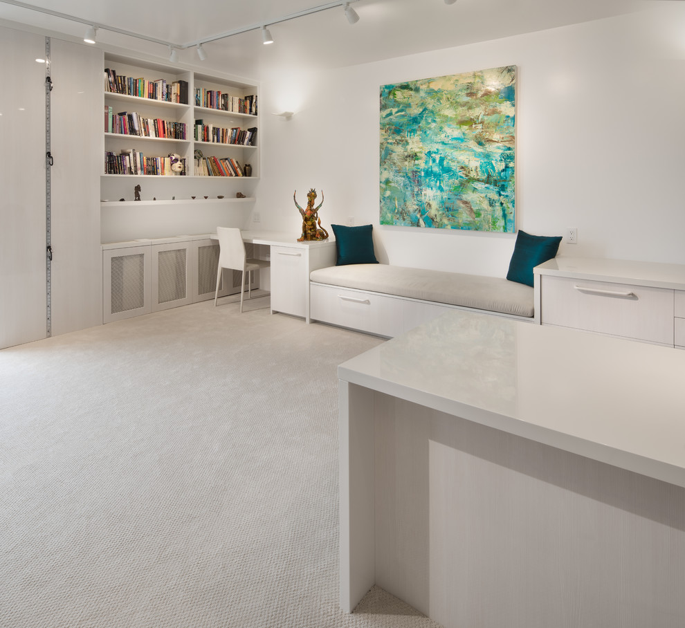 ワシントンD.C.にあるラグジュアリーな中くらいなコンテンポラリースタイルのおしゃれな書斎 (白い壁、カーペット敷き、造り付け机、ベージュの床) の写真