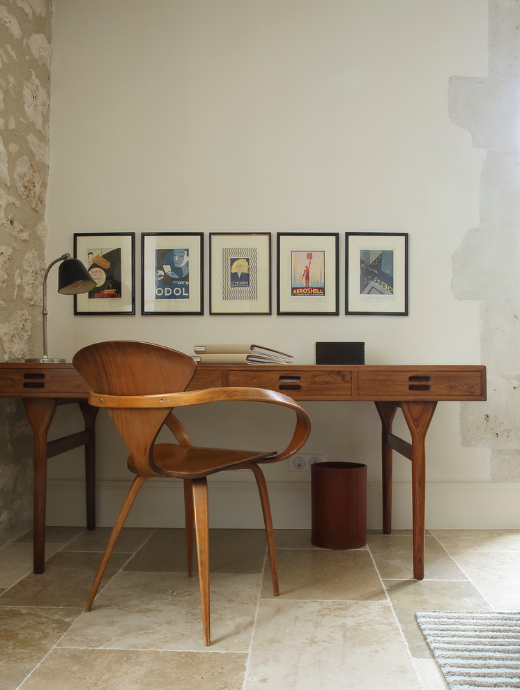 Design ideas for a midcentury study in New York with white walls and a freestanding desk.