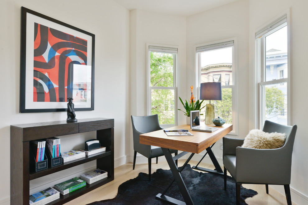 Medium sized contemporary study in San Francisco with light hardwood flooring and a freestanding desk.
