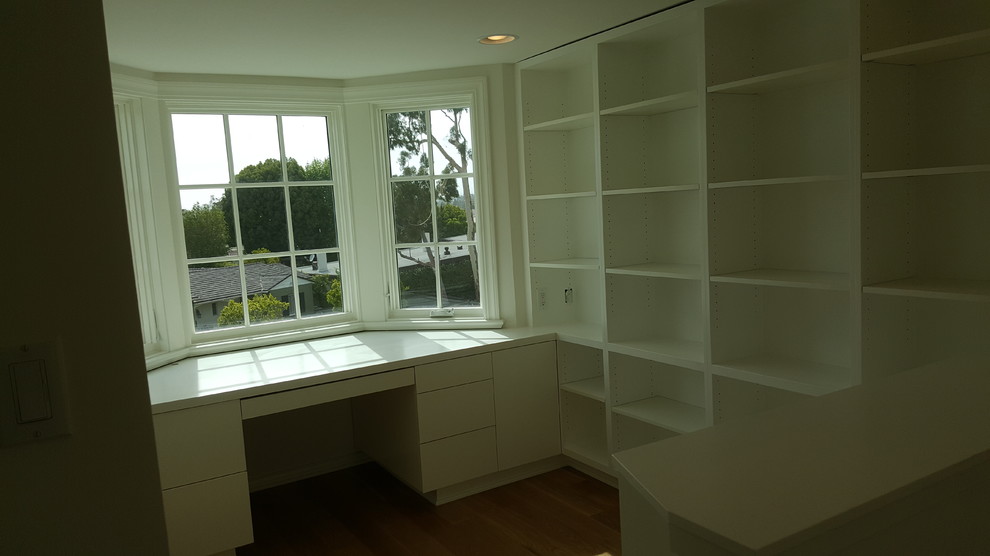 Example of a mid-sized 1960s built-in desk light wood floor study room design in Los Angeles with white walls