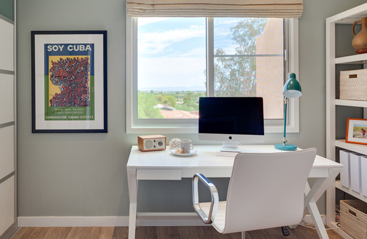 This is an example of a medium sized modern home office in Phoenix.