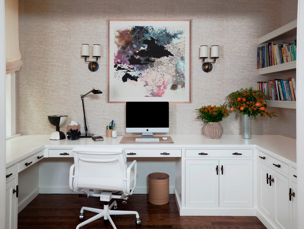 This is an example of a medium sized traditional study in New York with dark hardwood flooring and a built-in desk.