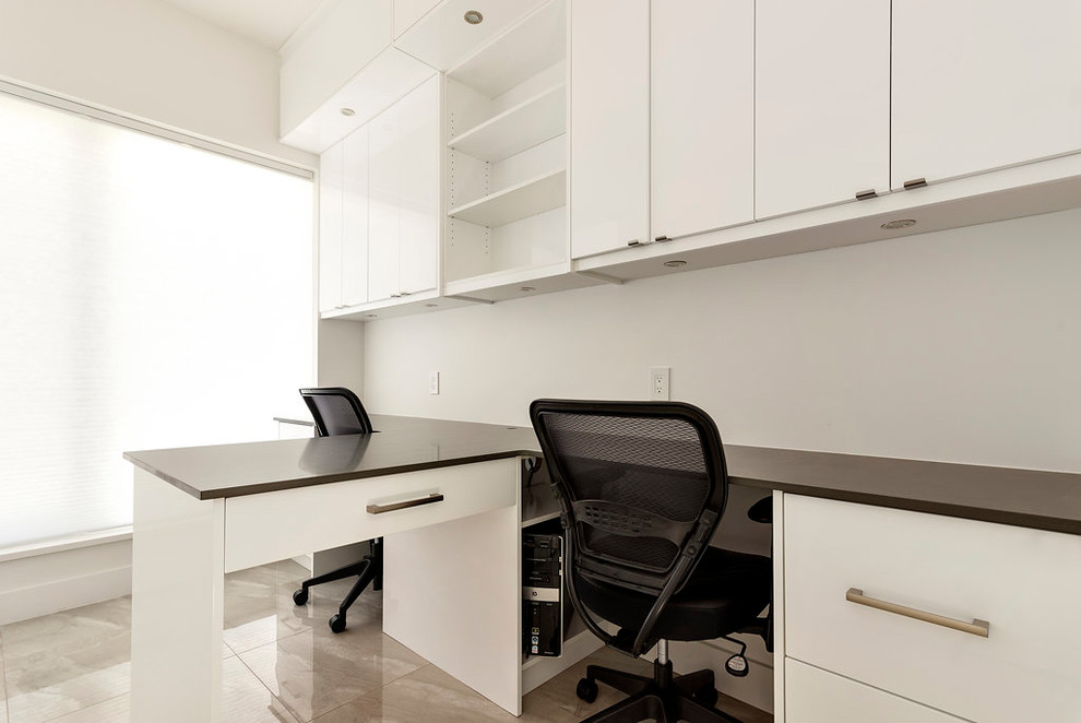 Example of a small trendy built-in desk porcelain tile and gray floor study room design in Vancouver with white walls