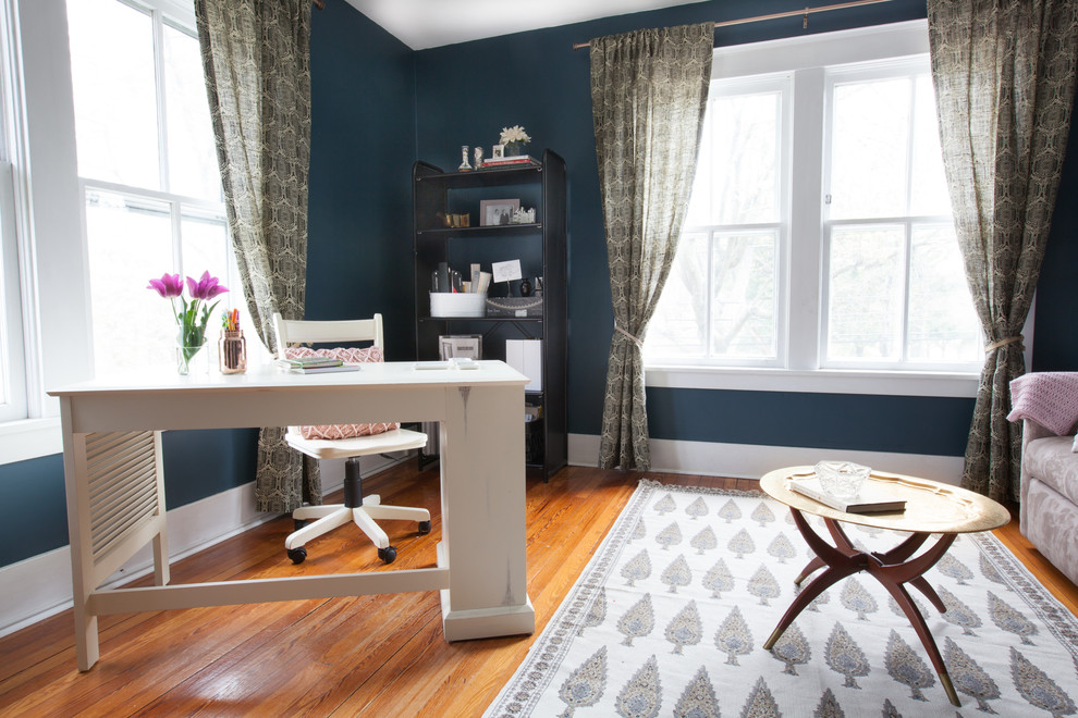 Ejemplo de despacho ecléctico pequeño con paredes azules y escritorio independiente