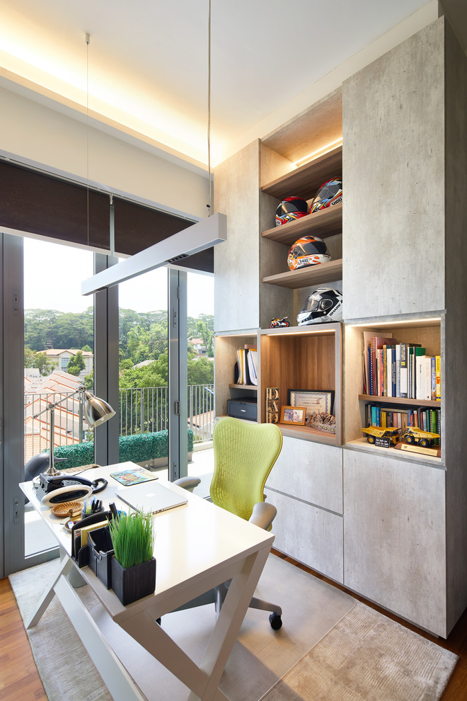 Home office - eclectic freestanding desk medium tone wood floor and brown floor home office idea in Singapore with white walls