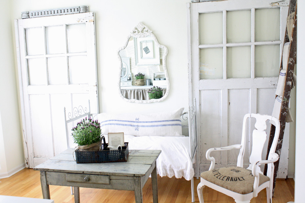 Home office - shabby-chic style medium tone wood floor home office idea in Chicago with white walls