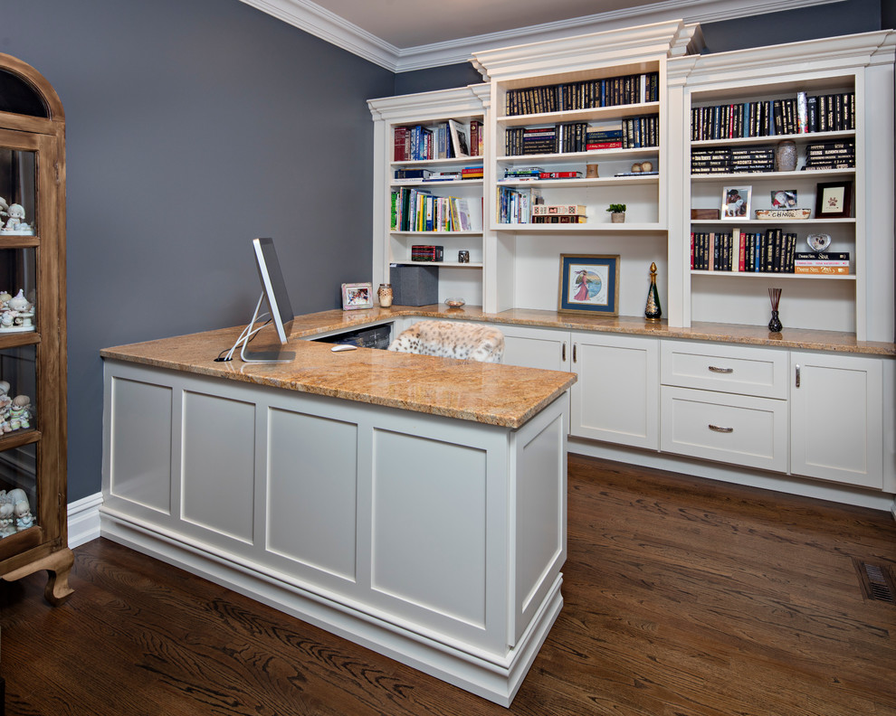 Mid-sized elegant built-in desk medium tone wood floor study room photo in New York with blue walls and no fireplace