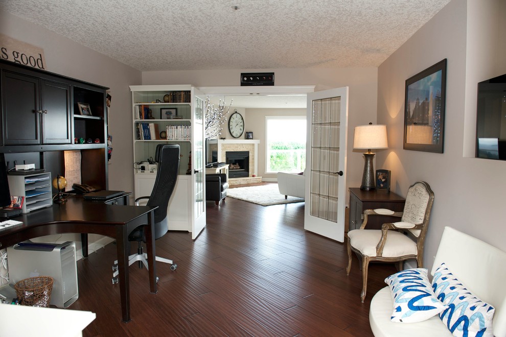 Example of a transitional home office design in Vancouver
