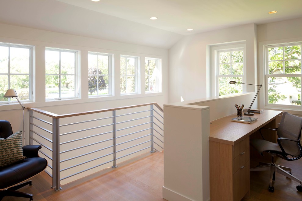 Inspiration for a contemporary home office in Minneapolis with white walls, medium hardwood flooring and a freestanding desk.