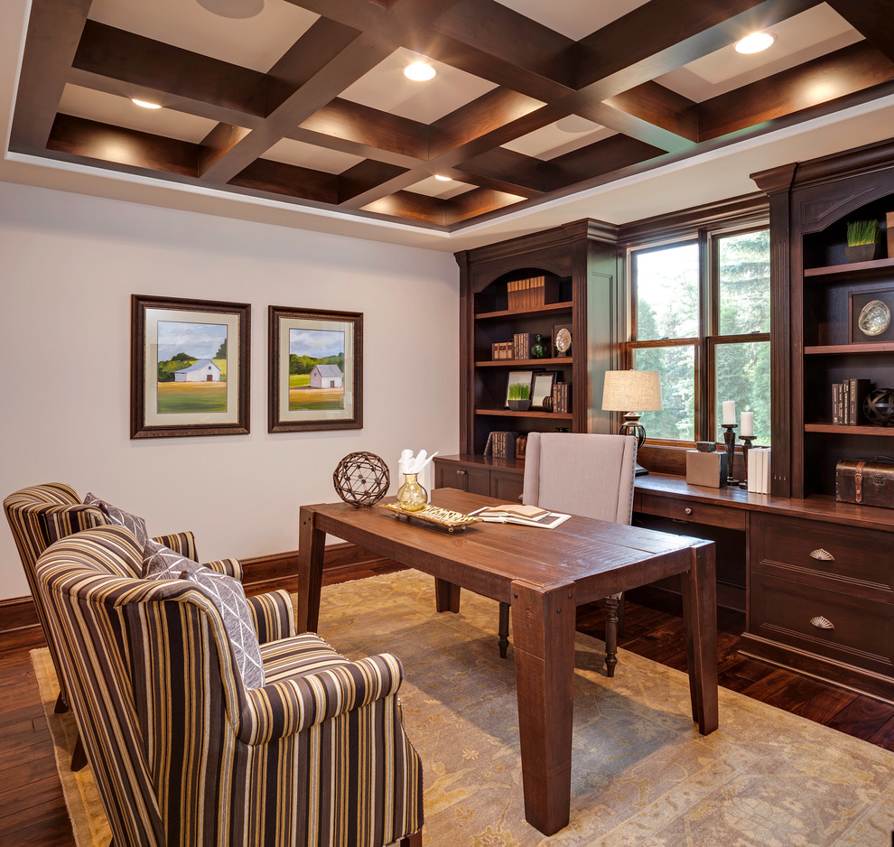 Inspiration for a timeless freestanding desk dark wood floor study room remodel in Minneapolis with beige walls