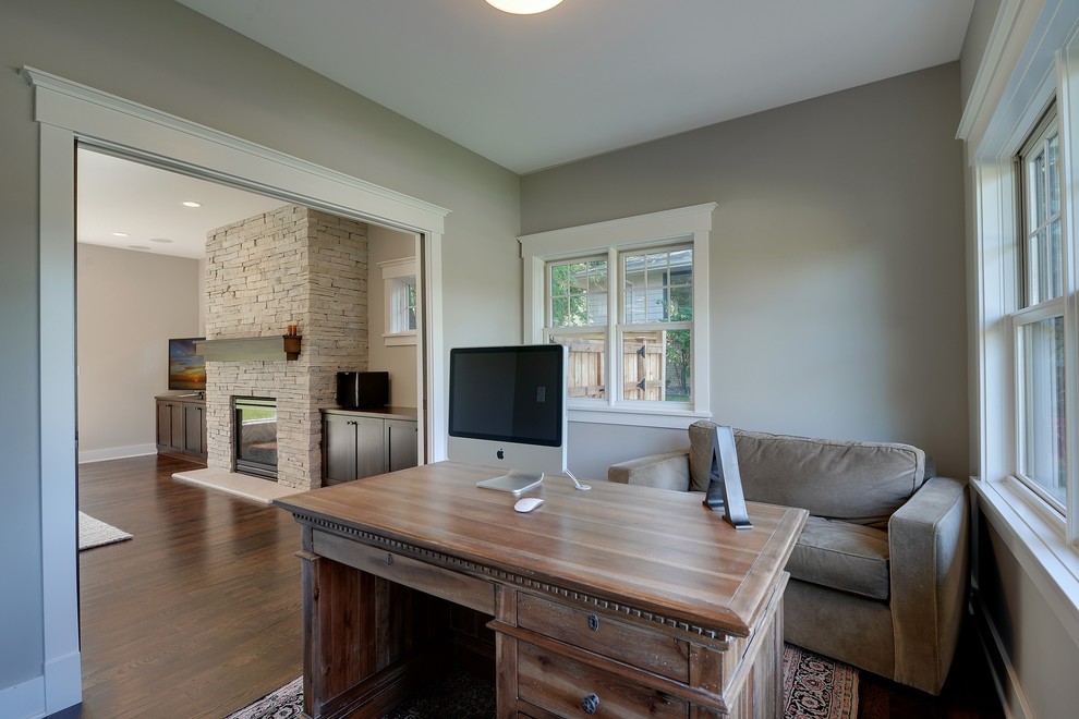 Example of a mid-sized arts and crafts freestanding desk dark wood floor study room design in Minneapolis with gray walls