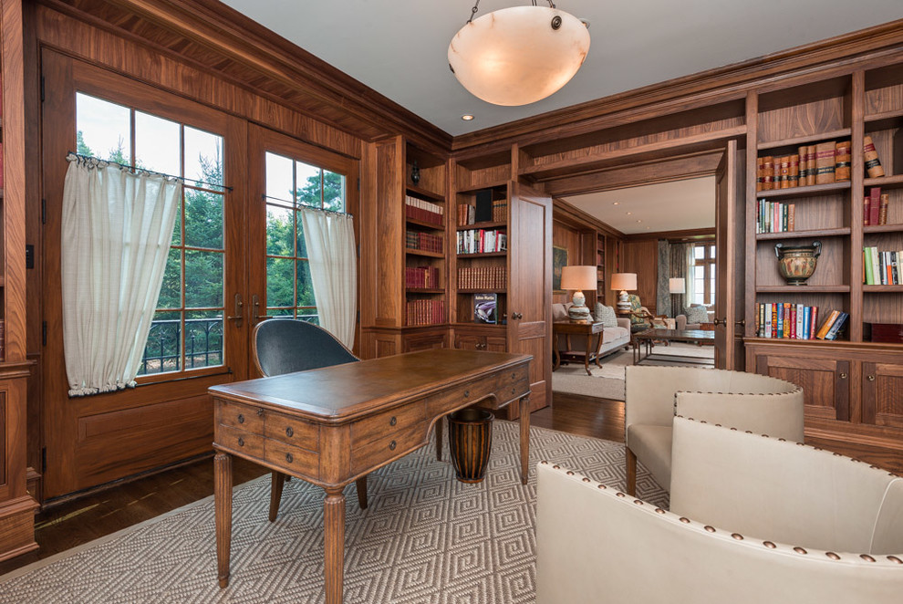 Inspiration for a large traditional study in Bridgeport with brown walls, dark hardwood flooring and a freestanding desk.