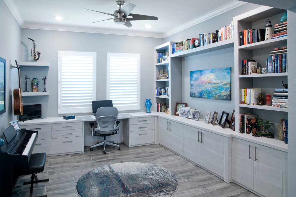 Large craft room in Miami with grey walls, porcelain flooring, a built-in desk and grey floors.